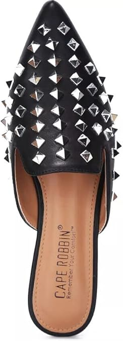 Slip into attitude with the Enny Studded Mules. Available in black faux leather or clear PVC, these pointed toe flats are your new go-to for effortless edge.